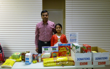 Food Raised for Food Bank – Sudhir Jha, and Daughter